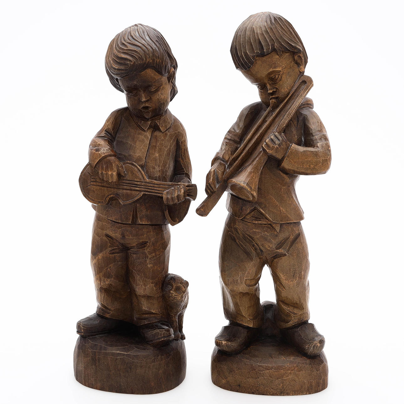 WOODEN FIGURES, 2 pieces, boys with instruments, signed S.C.