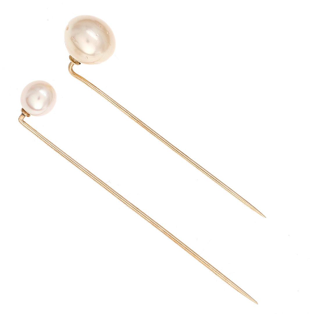 Two tie pins with pearls.