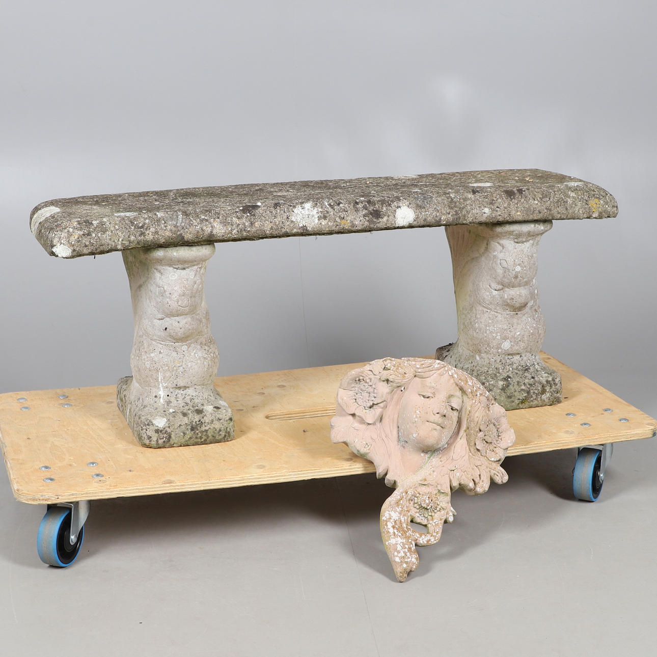 A RECONSTITUTED STONE GARDEN SEAT.