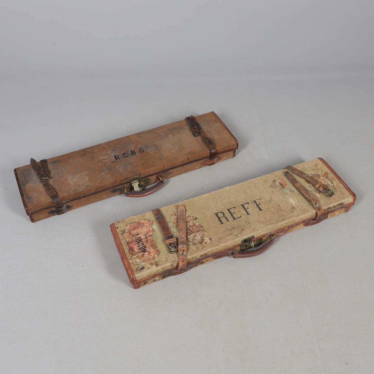 TWO VINTAGE LEATHER & CANVAS SHOT GUN CASES.