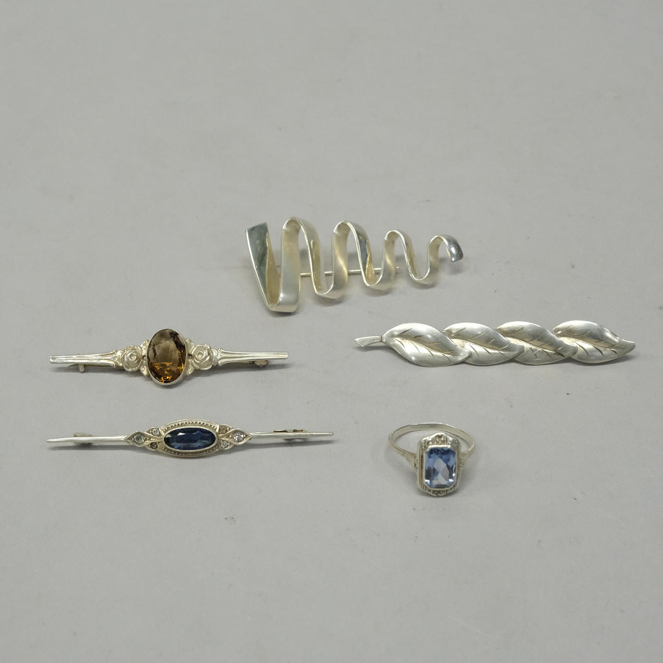 FOUR BROOCHES AND A RING, SILVER.