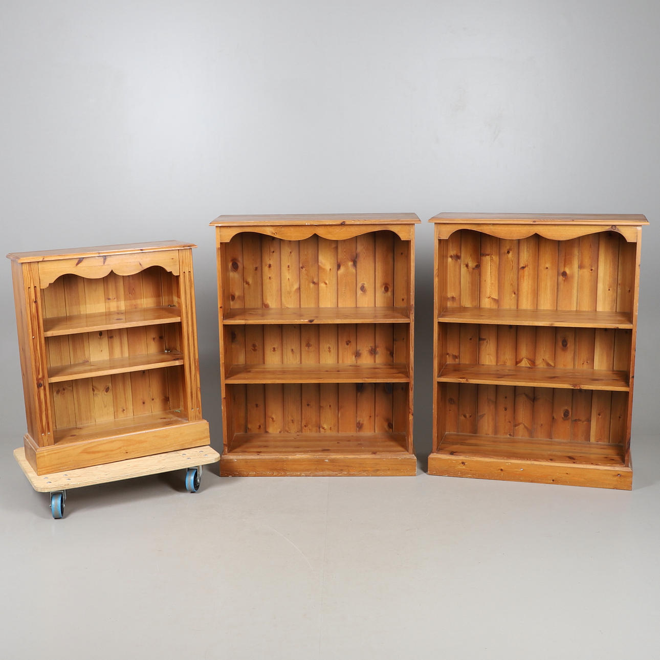 A PAIR OF PINE BOOKSHELVES, AND ANOTHER SMALLER SIMILAR.