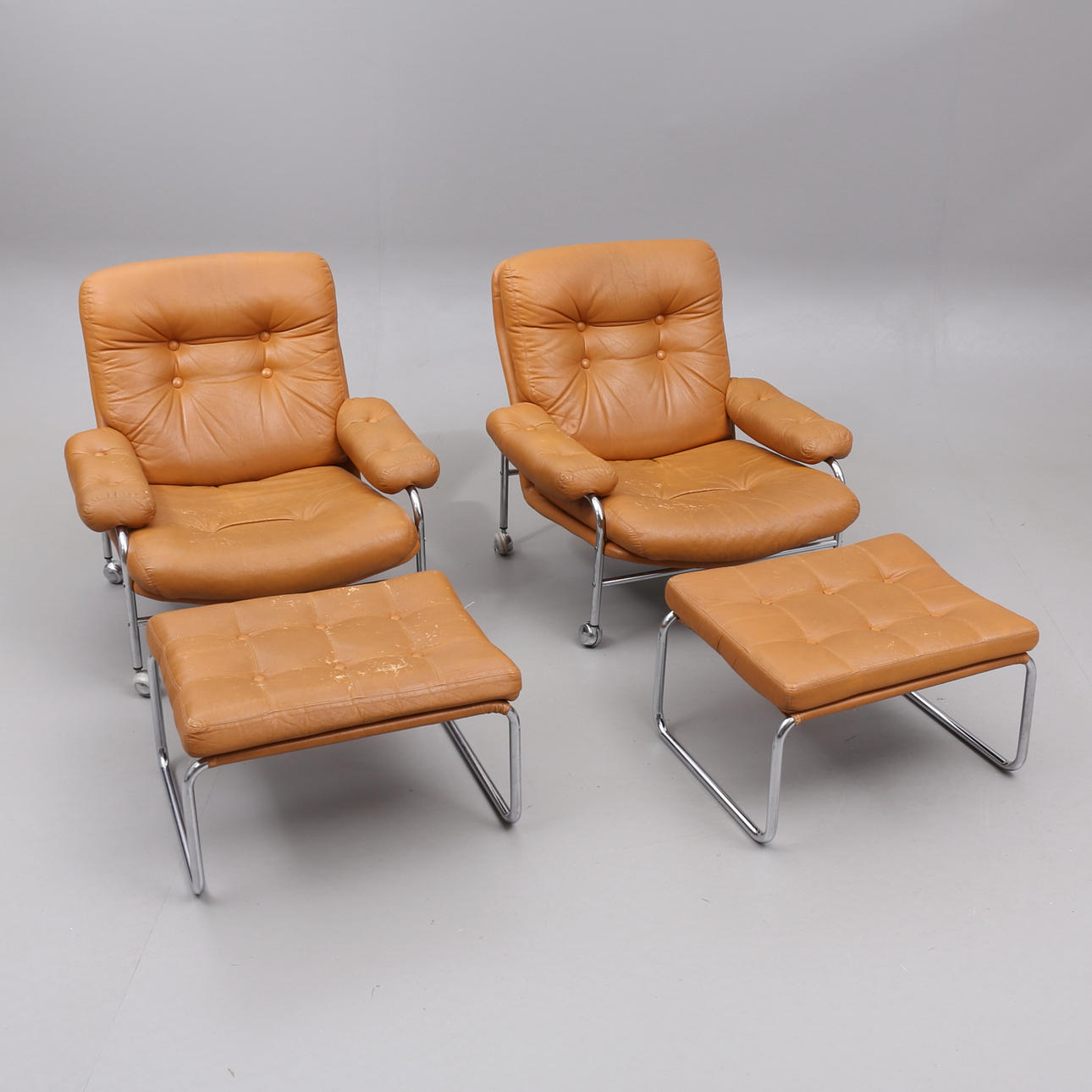 A pair of armchairs with footstools, artificial leather and chromed undercarriage, “Kimo”, Ulferts, 1970s.