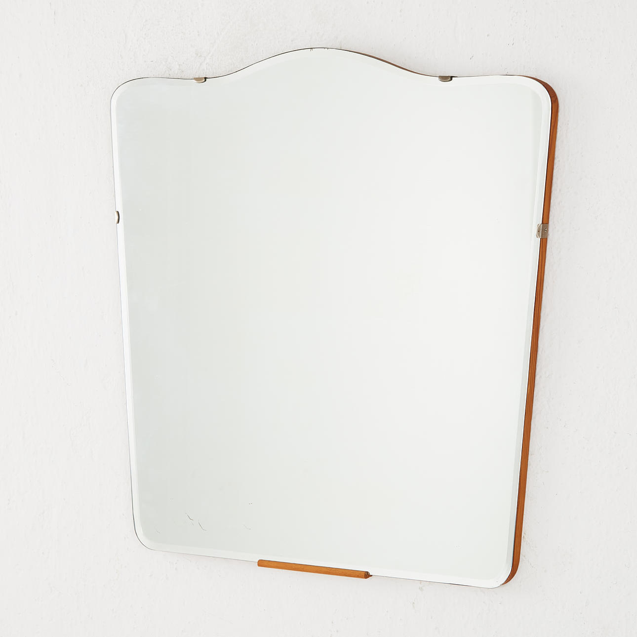 A 1940's wall mirror, pine, faceted glass.