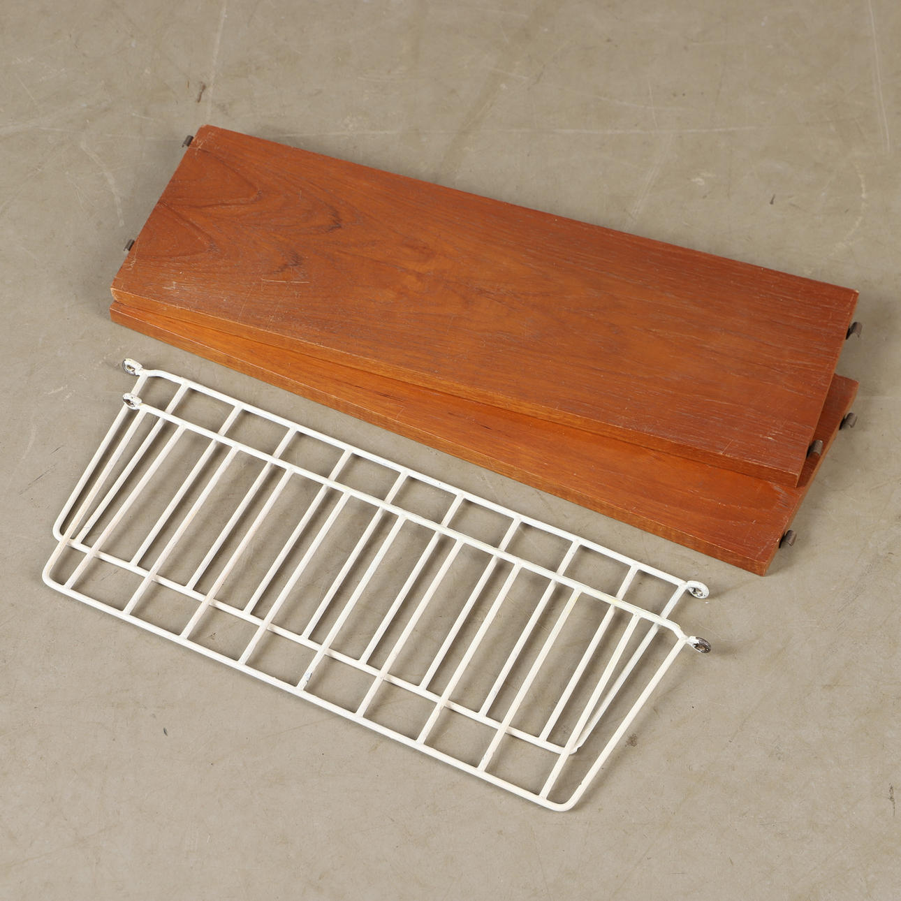 A mid 20th century teak string wall shelf.
