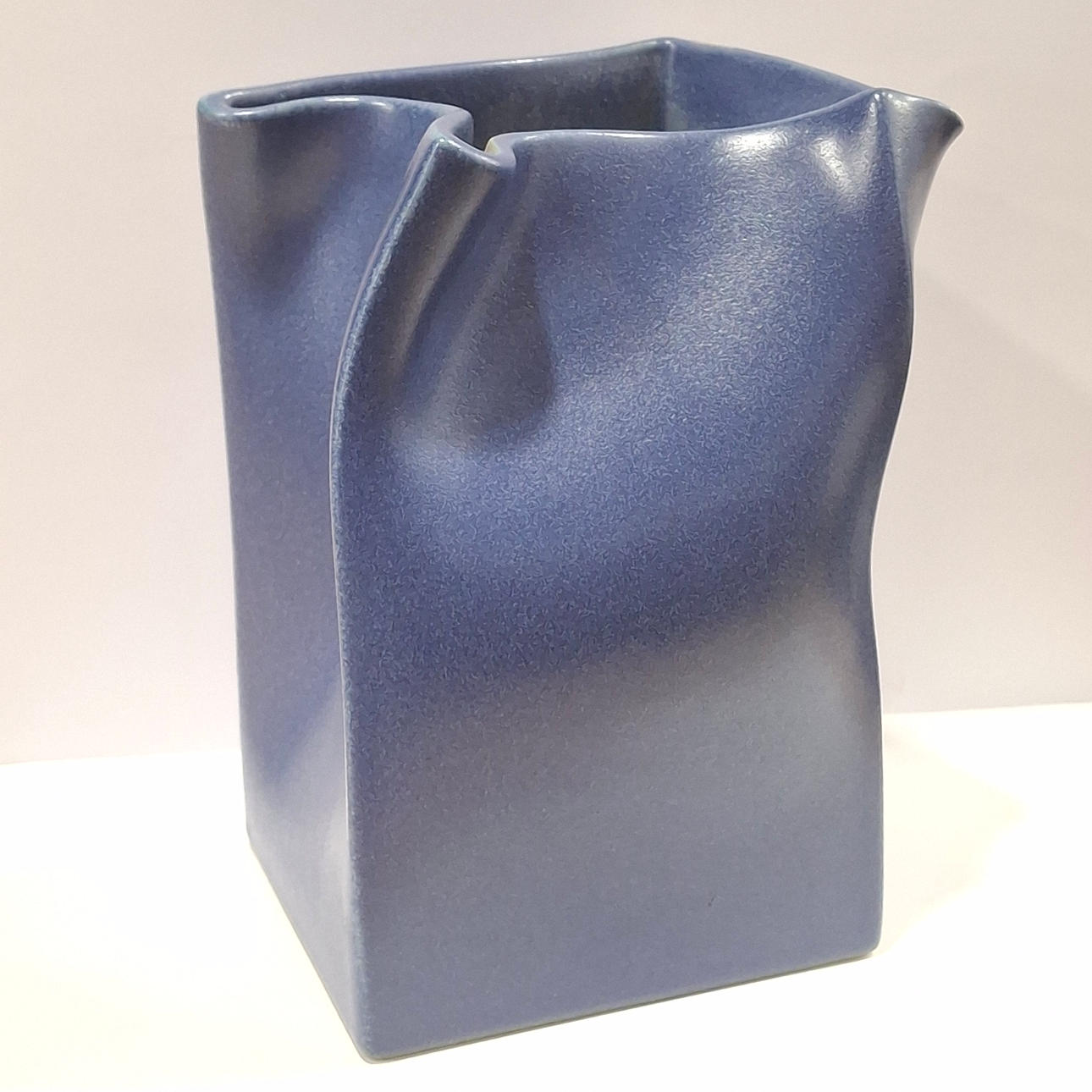 THE FOURTH IS GROWING. Signed. Vase with an irregular design in blue glazed ceramic.