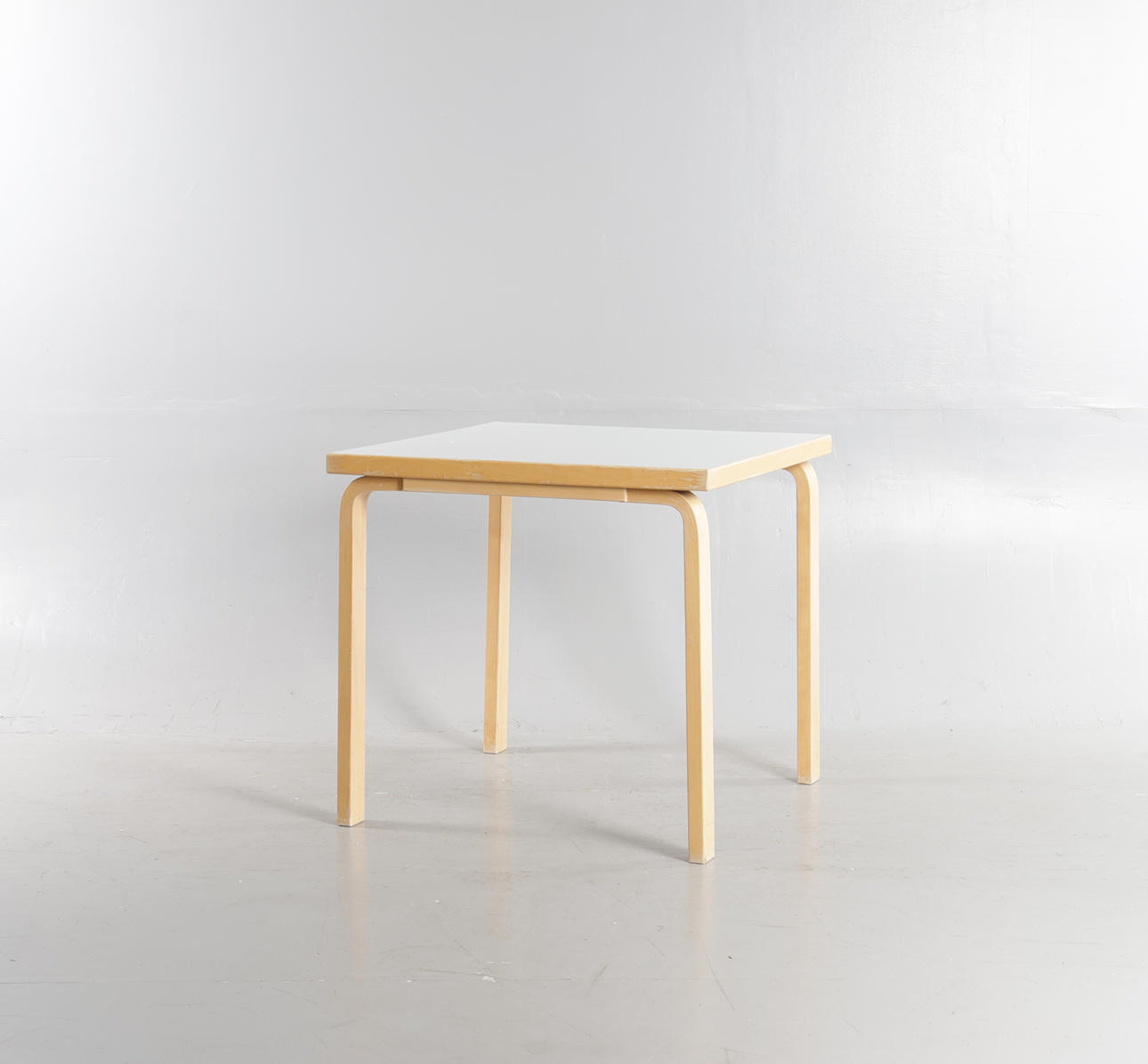 ALVAR AALTO. Square dining table made of birch with white laminate, Artek, Finland.