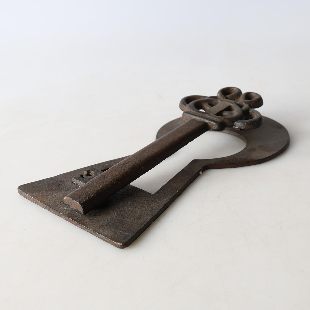 A cast-iron door knocker, 20th century.