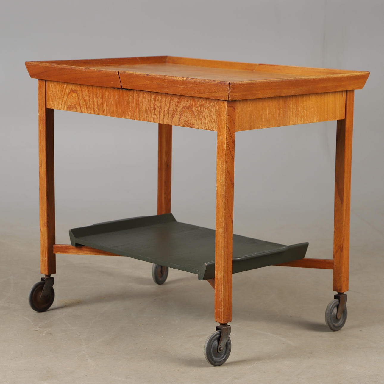 A teak serving trolley with painted top, mid 20th century.
