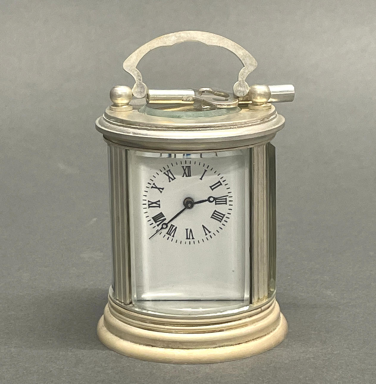 SMALL SILVERED BRASS CARRIAGE CLOCK.