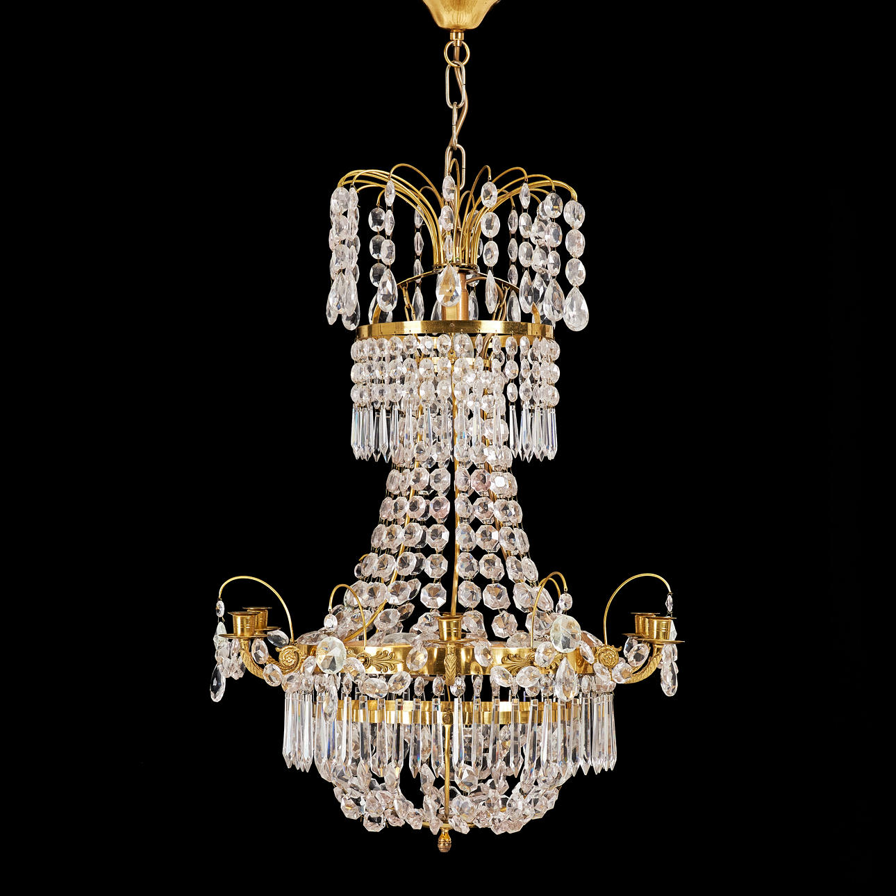 CHANDELIER. Second half of the 20th century, frame made of brass, hung with different cut prisms.