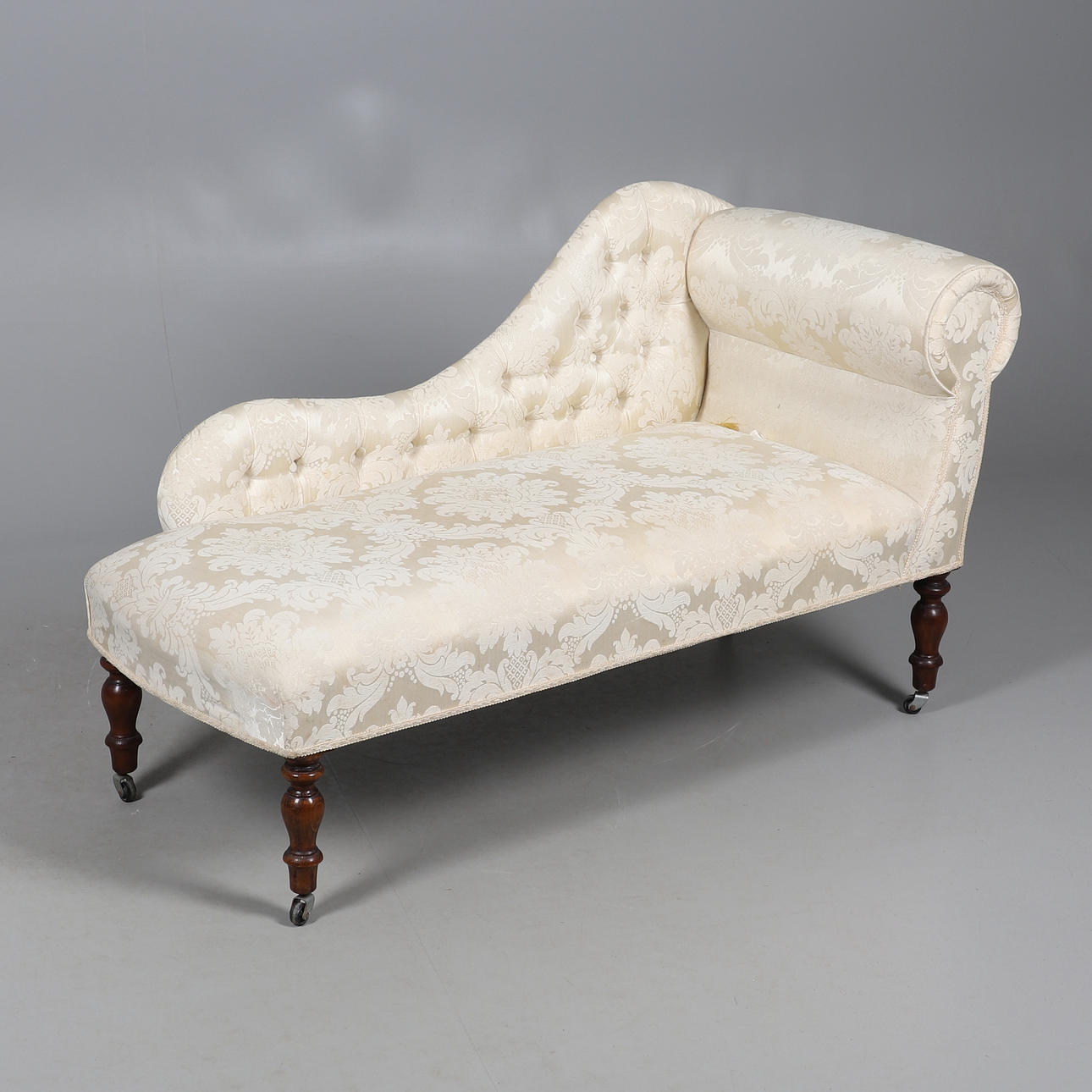 A REPRODUCTION SCROLL END CHAISE LONGUE.