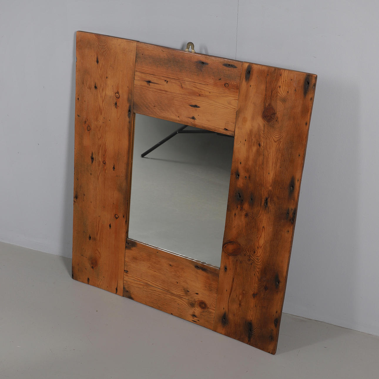 A RECLAIMED WOOD WALL MIRROR.