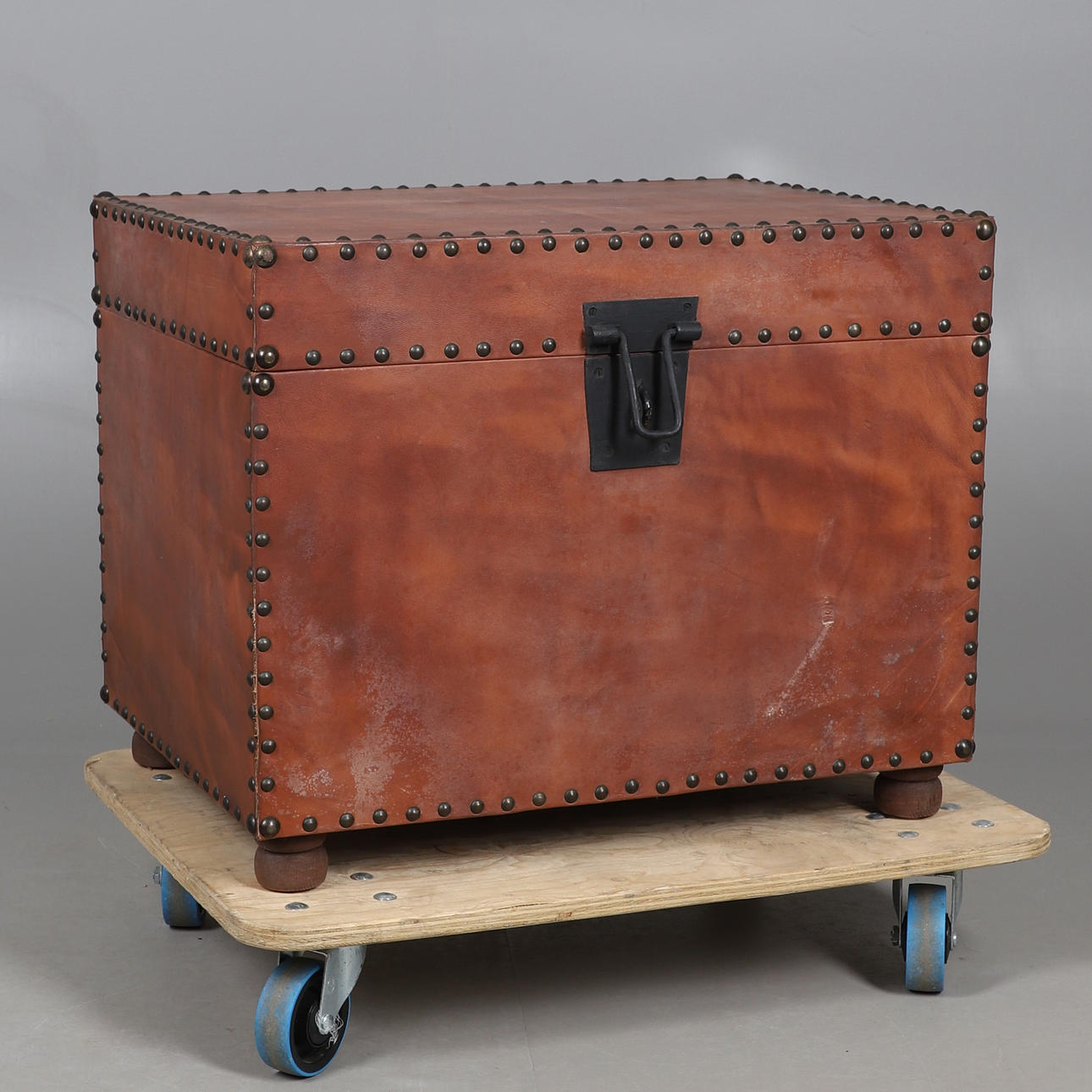 A SUEDE COVERED TRUNK WITH CLOSE STUD DECORATION.