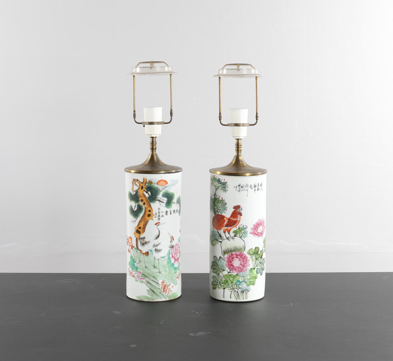 Two Chinese vases, cylindrical, decorated in enamel colors with a rooster and cranes, respectively. Republic. One stamped. Mounted for lamps (2).