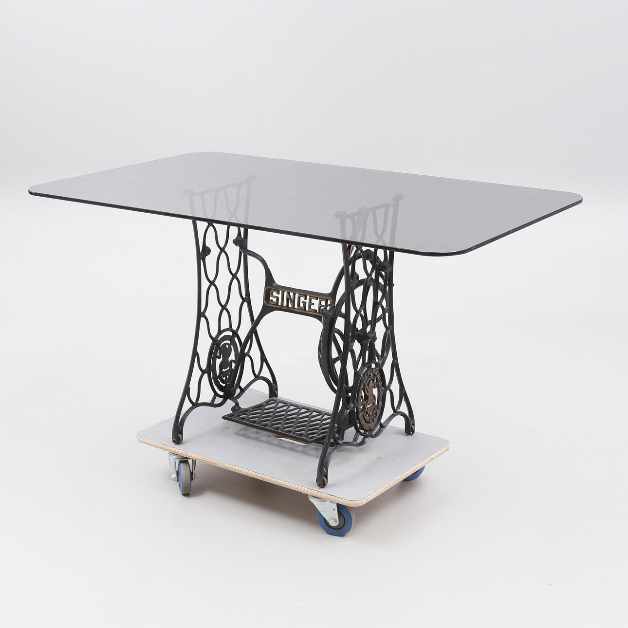 TABLE with cast iron base and glass top.