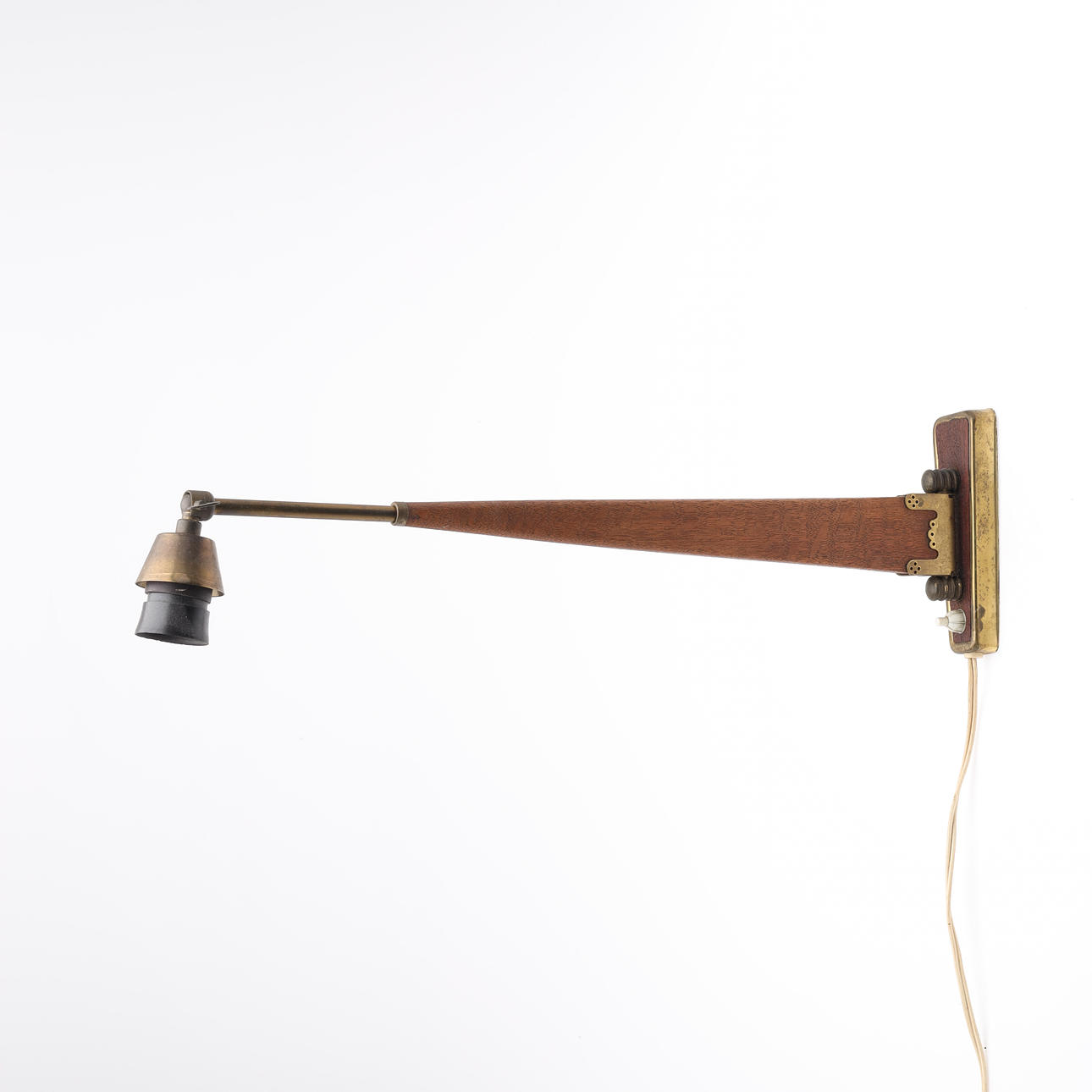 Adjustable wall lamp in patinated oak and brass with decorative details, Danish lamp manufacturer, mid 1900s.
