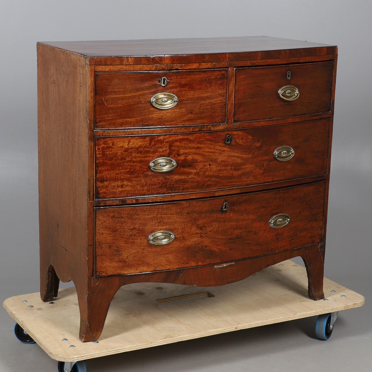 A MAHOGANY BOW FRONTED TWO SHORT AND TWO LONG DRAWERS.