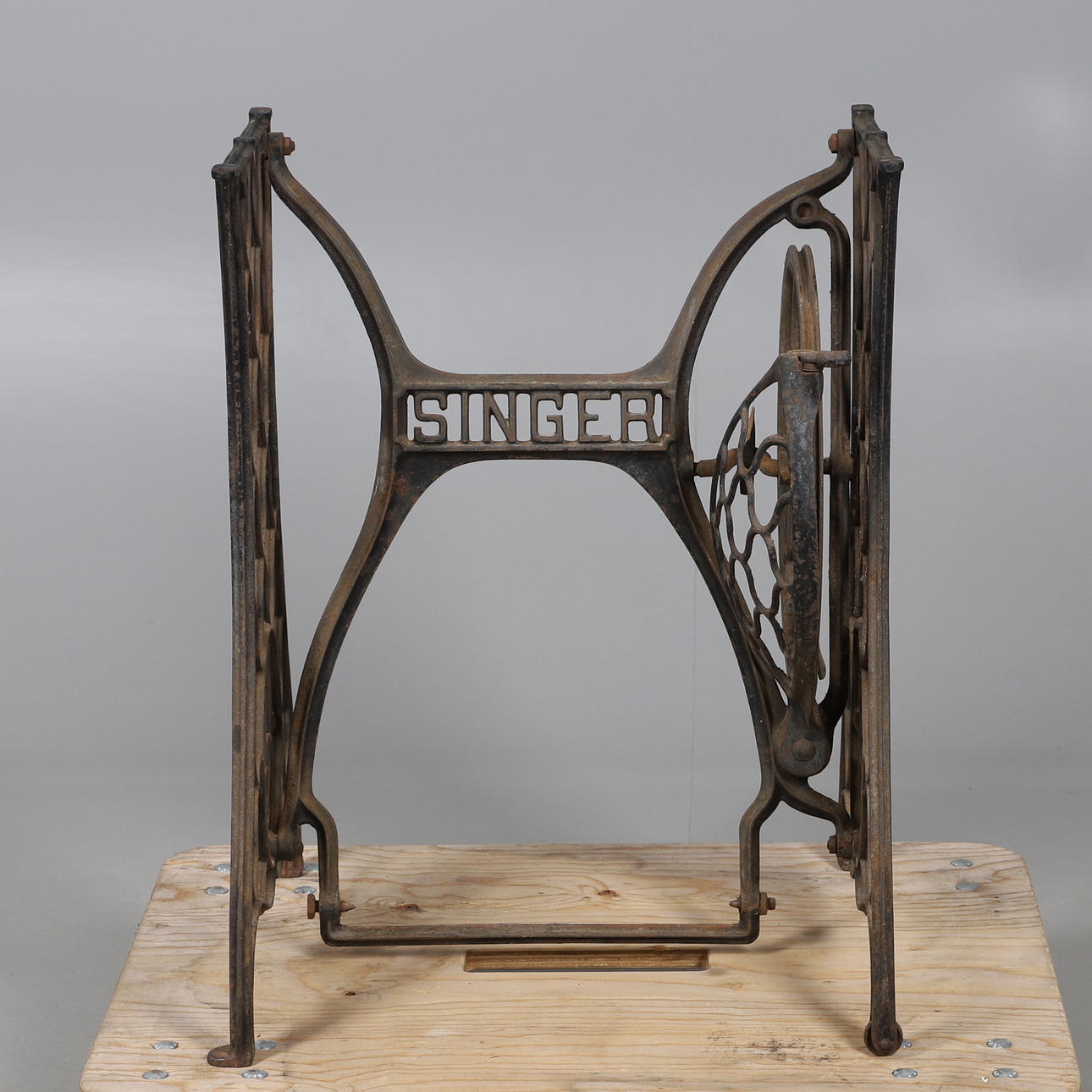 A CAST IRON SINGER SEWING MACHINE BASE.