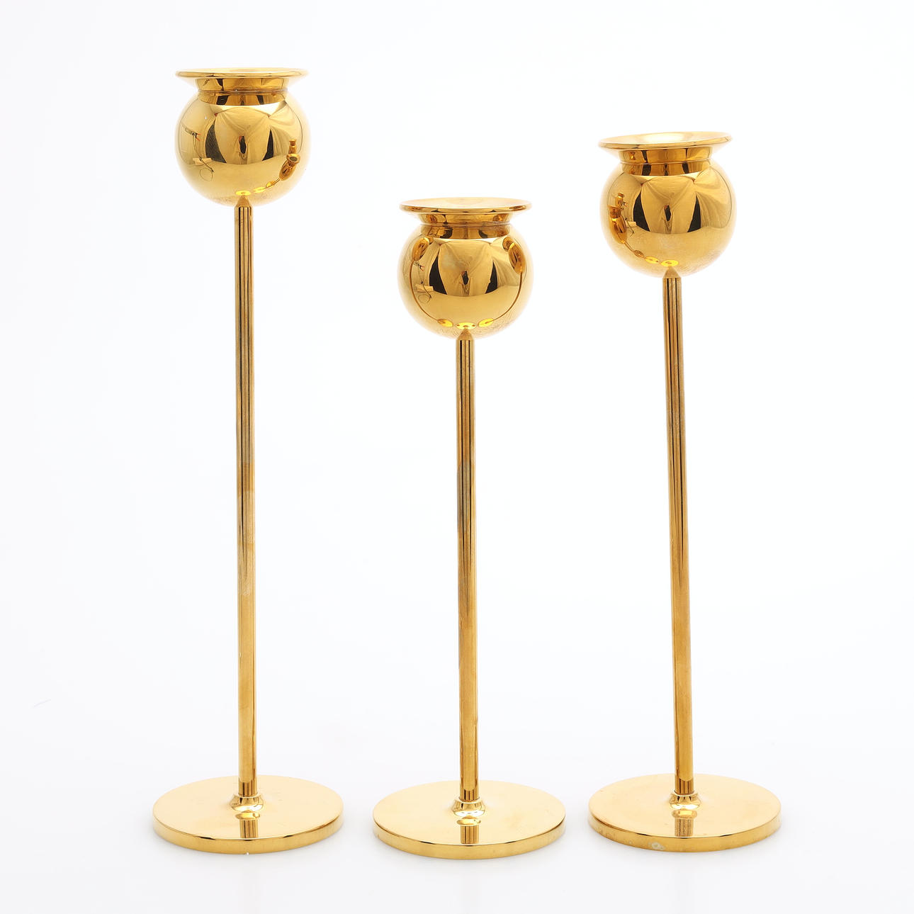 PIERRE FORSSELL. A set of three brass “Tulip” candlesticks, Skultuna, second half of the 20th century.