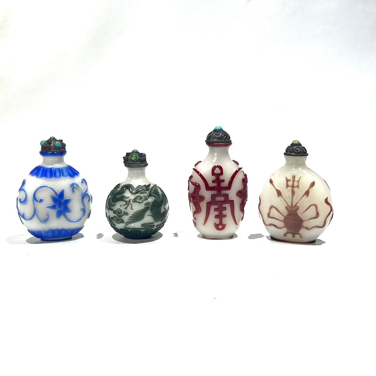 Four fiberglass tobacco bottles worked with plant and animal motifs.  Asiatica - Ceramics & Porcelain