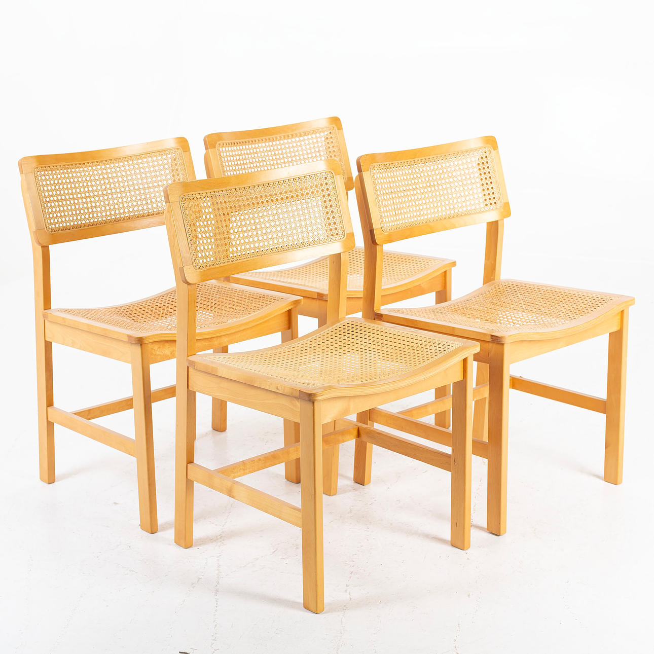 A set of 4 chairs, frame of birch, backrest and seat in rattan, second half of the 20th century.
