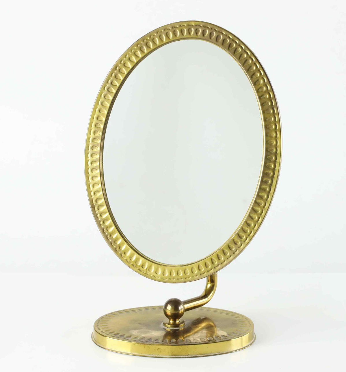 A brass “Titti” table mirror, 20th century.