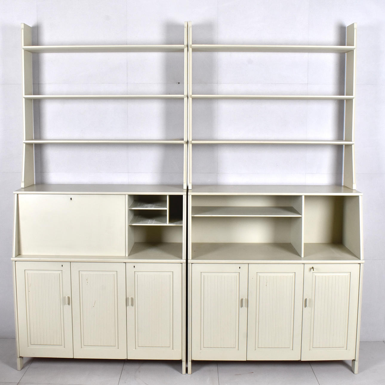 CARL MALMSTEN. Bookshelves, 2-sections “Visingsö”, white lacquered, top with shelf bottoms with cupboards, shelf decoration.