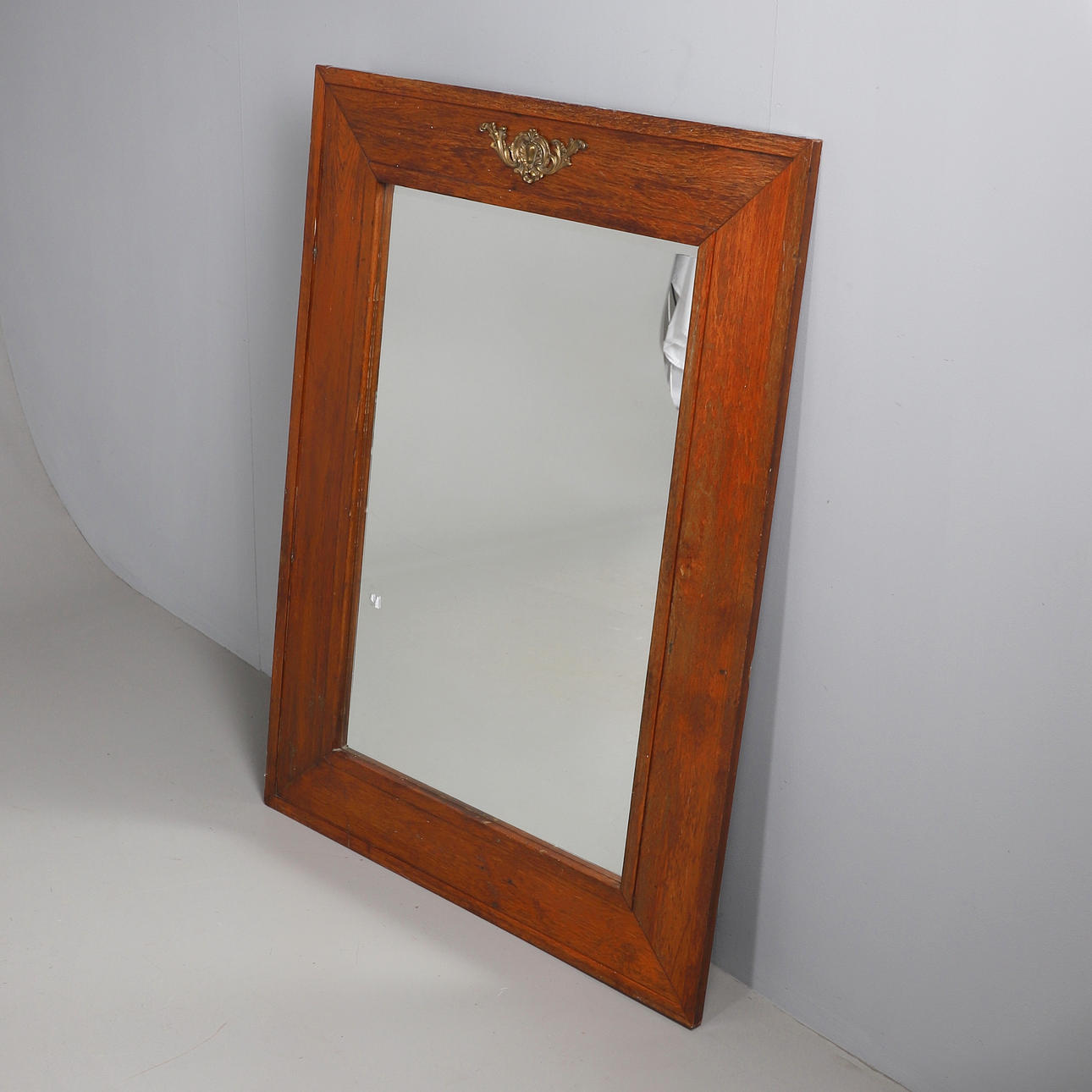 A FRENCH WALNUT FRAMED MIRROR.