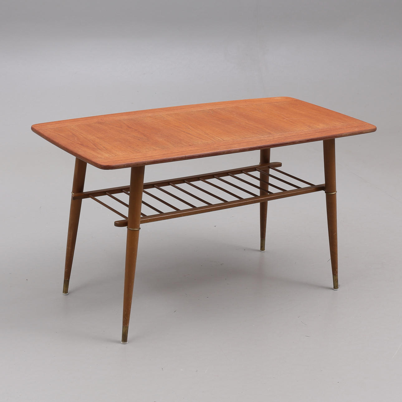 A mid 20th century coffee table with magazine shelf.