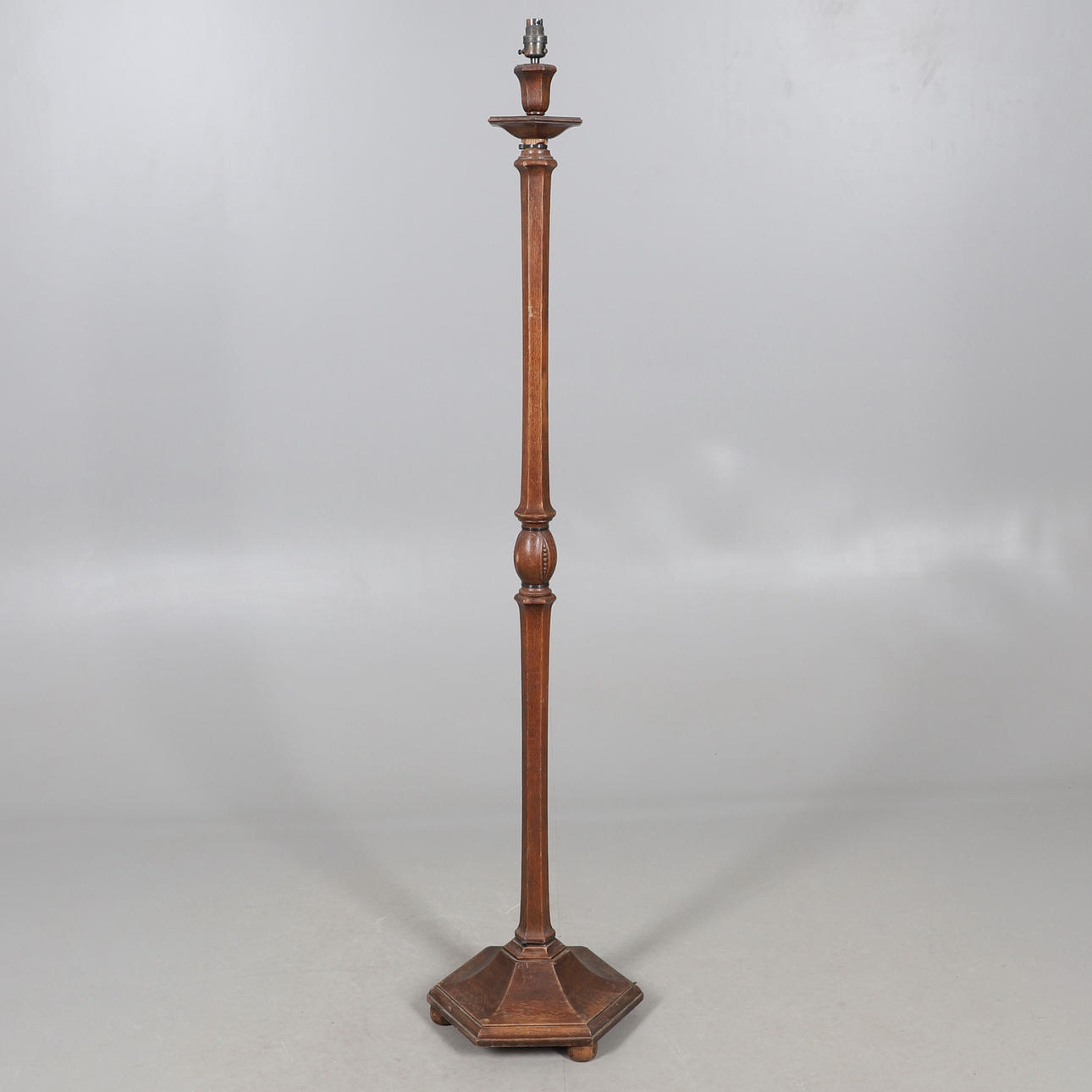 A 1920'S OAK LAMP STANDARD.