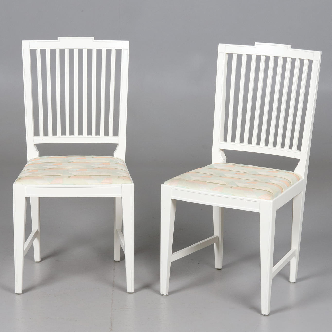 A pair of Gustavian style chairs.