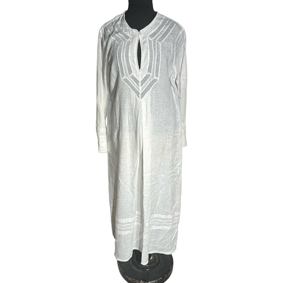 White linen kaftan with openwork details.