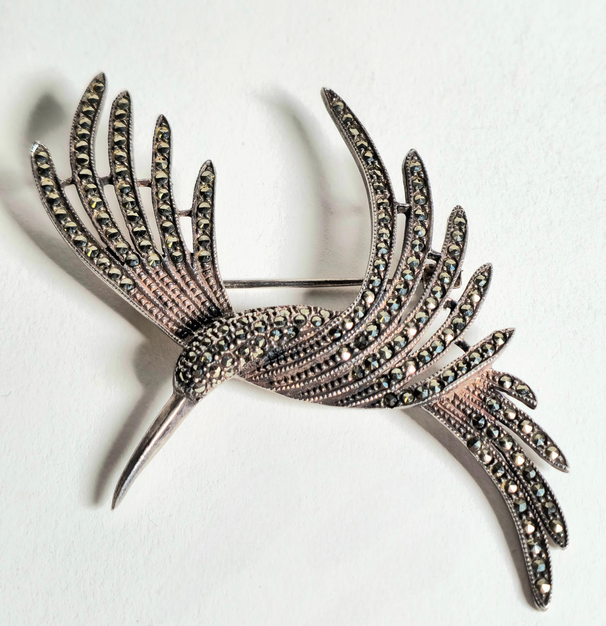 SILVER BIRD BROOCH WITH MARQUESITAS.