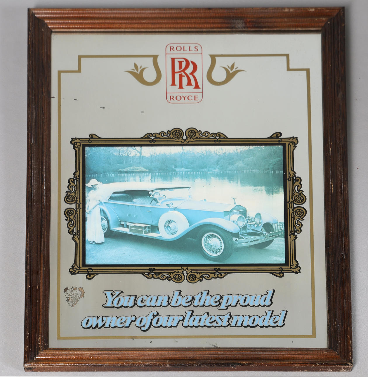 A ROLLS-ROYCE ADVERTISING MIRROR.
