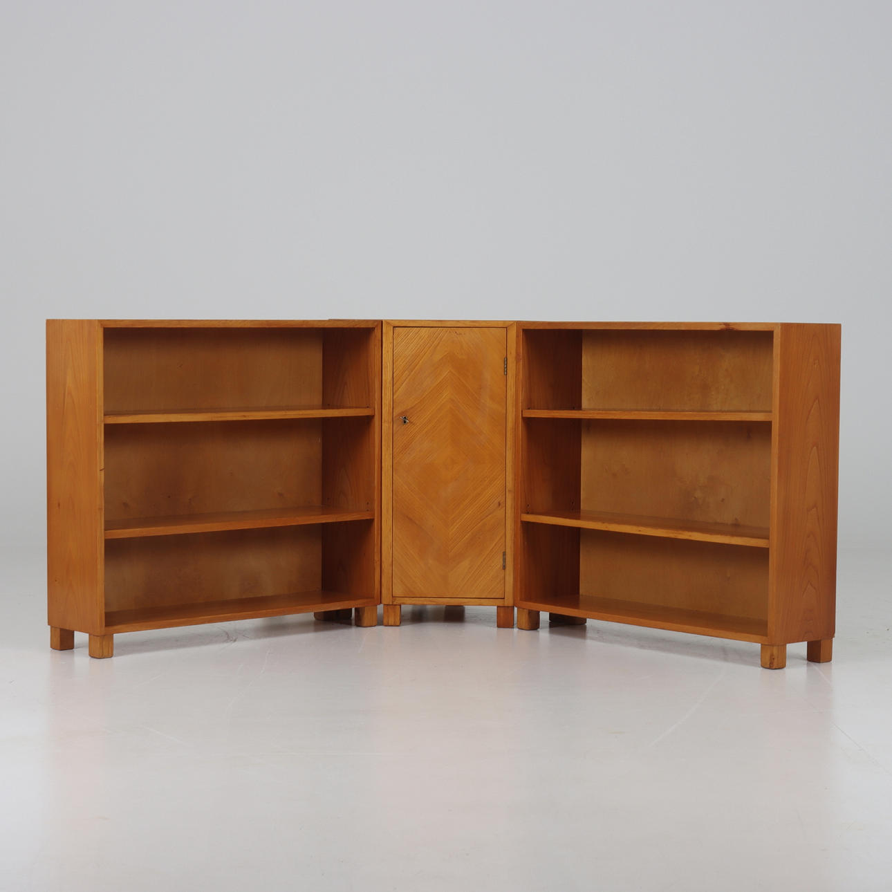 A three-piece corner bookcase, birch veneer, 1930-40's.