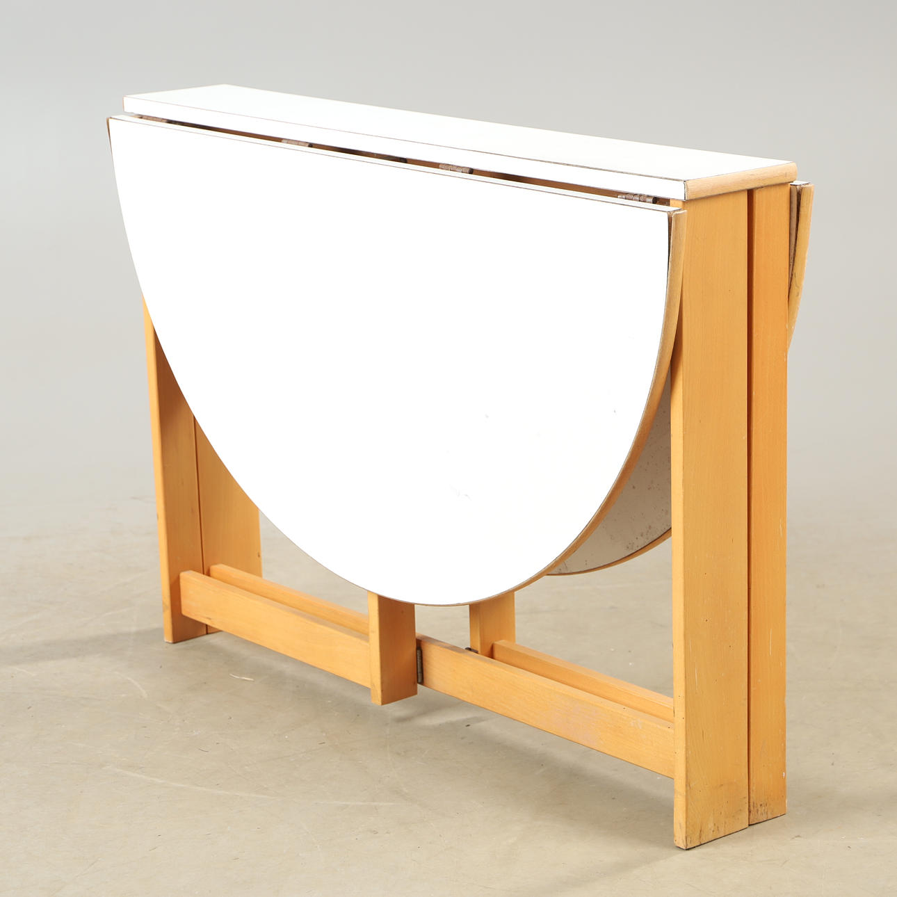 A “Vansbro” folding table, laminate and beech, IKEA, late 20th century.