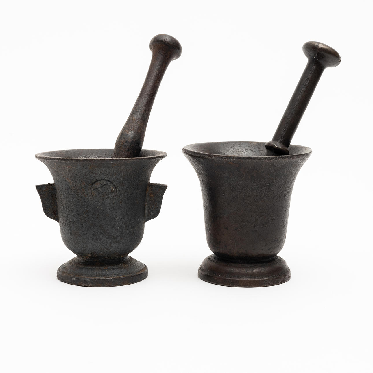 2 cast-iron pestle mortars, 19th century.