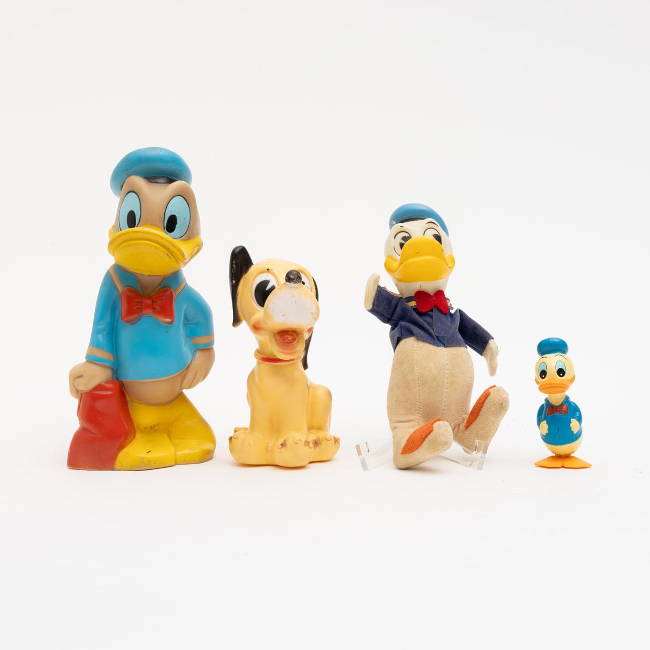 WALT DISNEY, 4 Donald Duck figurines, Pluto.