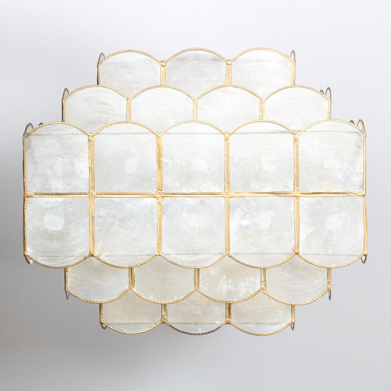A SEASHELL AND BRASS LIGHT SHADE.