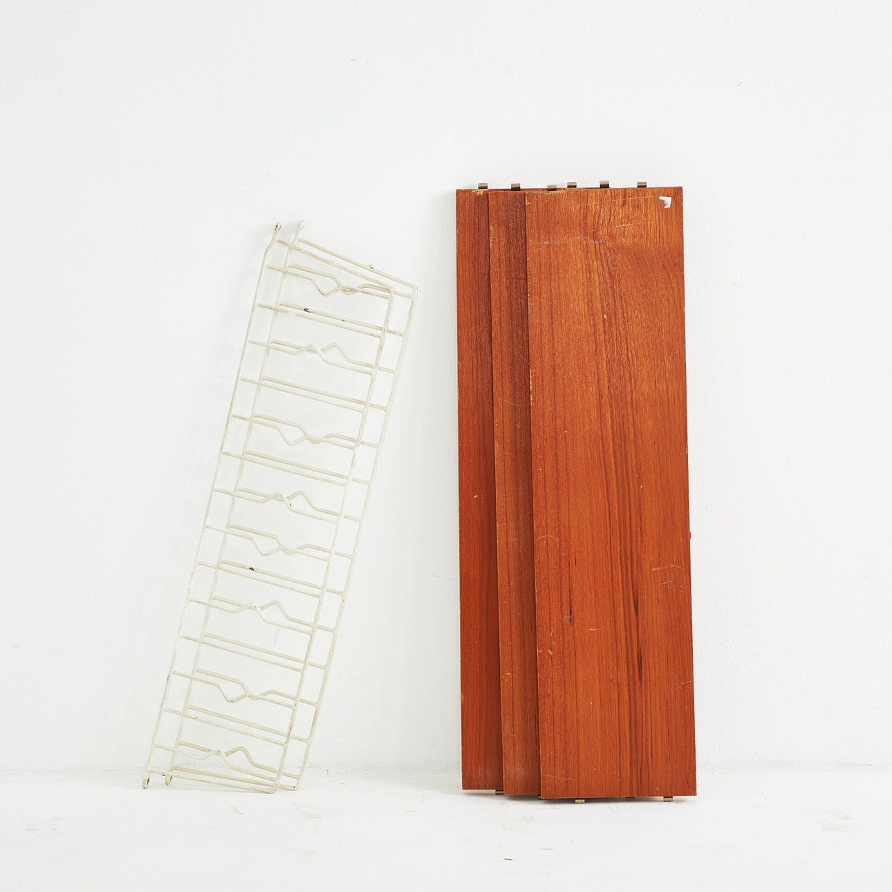 A mid 20th century wall shelf, String-type, shelves veneered with teak ...