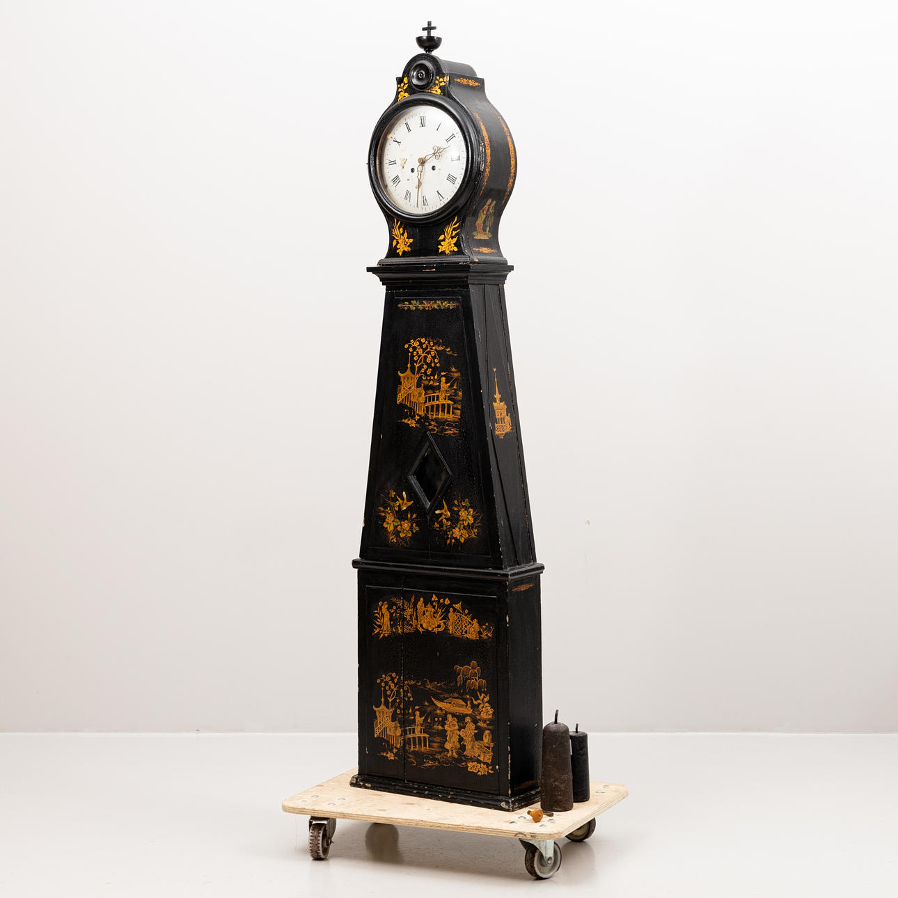 A 19th century floor clock, painted with later Chinese decoration.