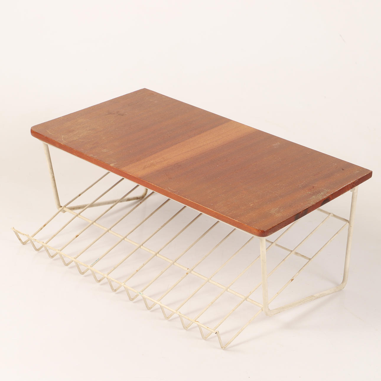 A mid 20th century string/mahogany magazine shelf.