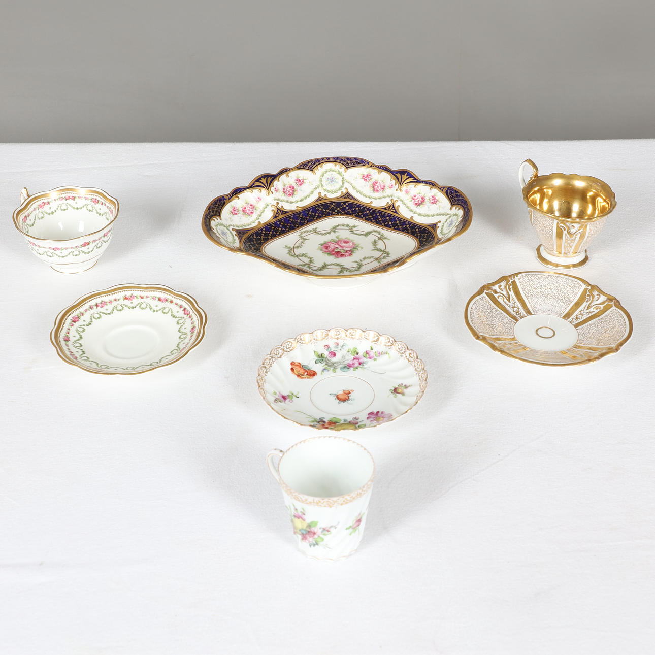THREE CABINET CUPS AND SAUCERS AND A DESSERT DISH.