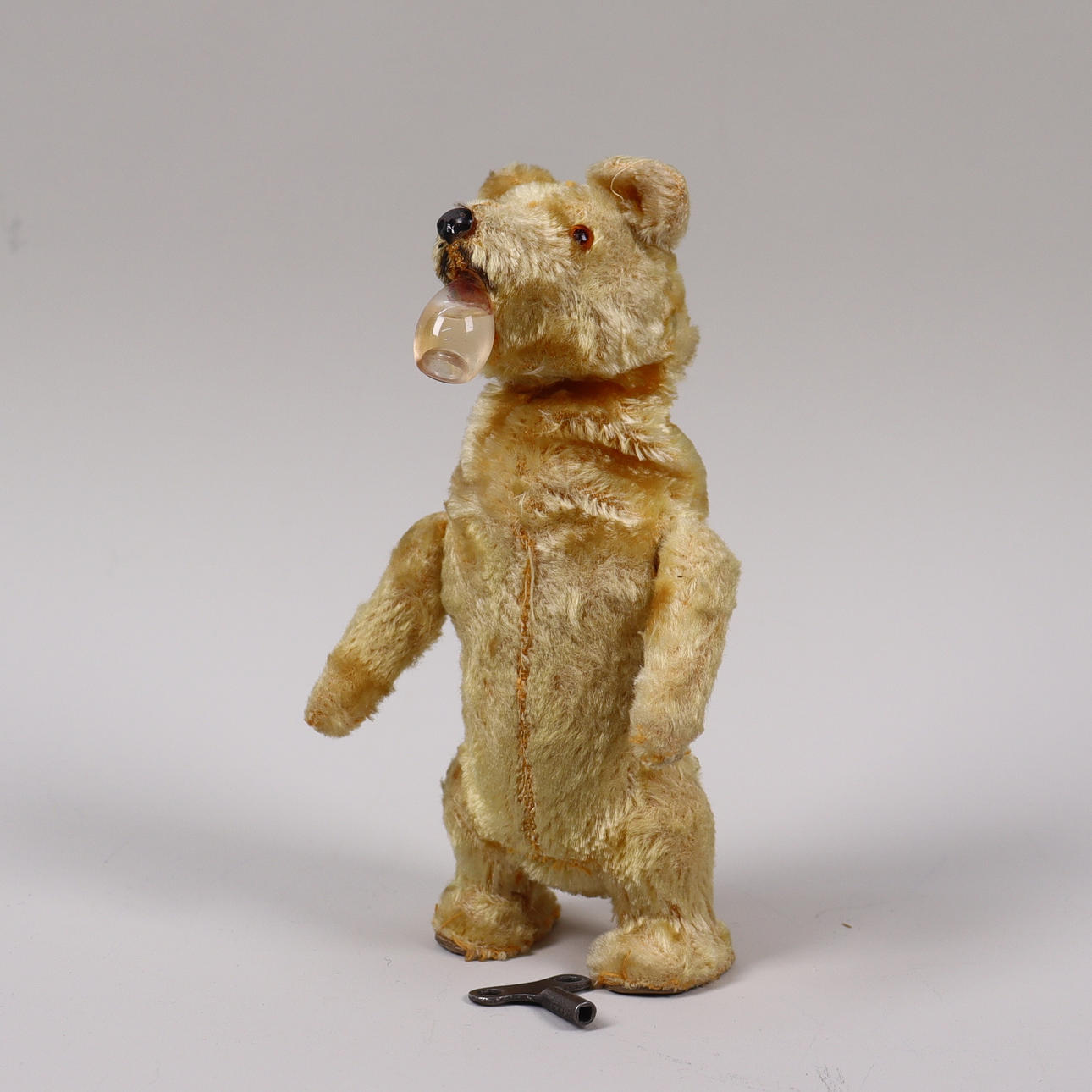A toy bear, probably Germany, dancing and drinking, clockwork, mid 20th century.