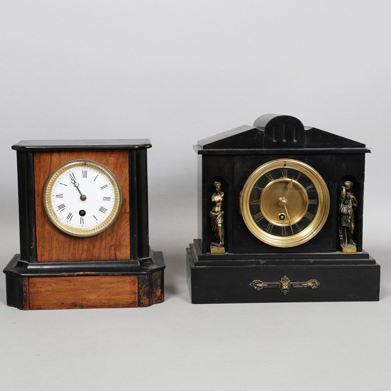 A LATE VICTORIAN BLACK SLATE MANTEL CLOCK AND A WALNUT CLOCK (2).