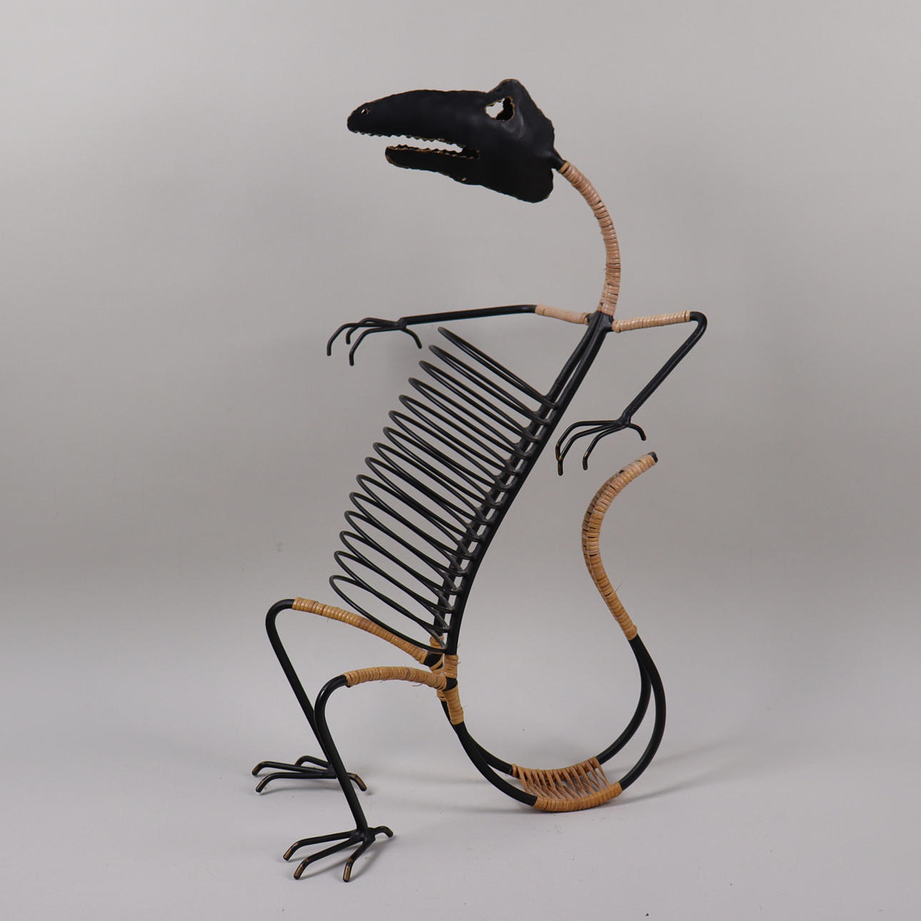 CD stand, dinosaur shape, metal.