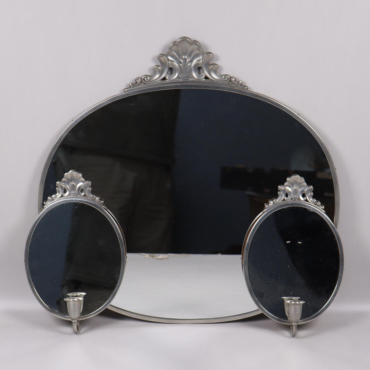 A 1930s pewter mirror and chandelier.