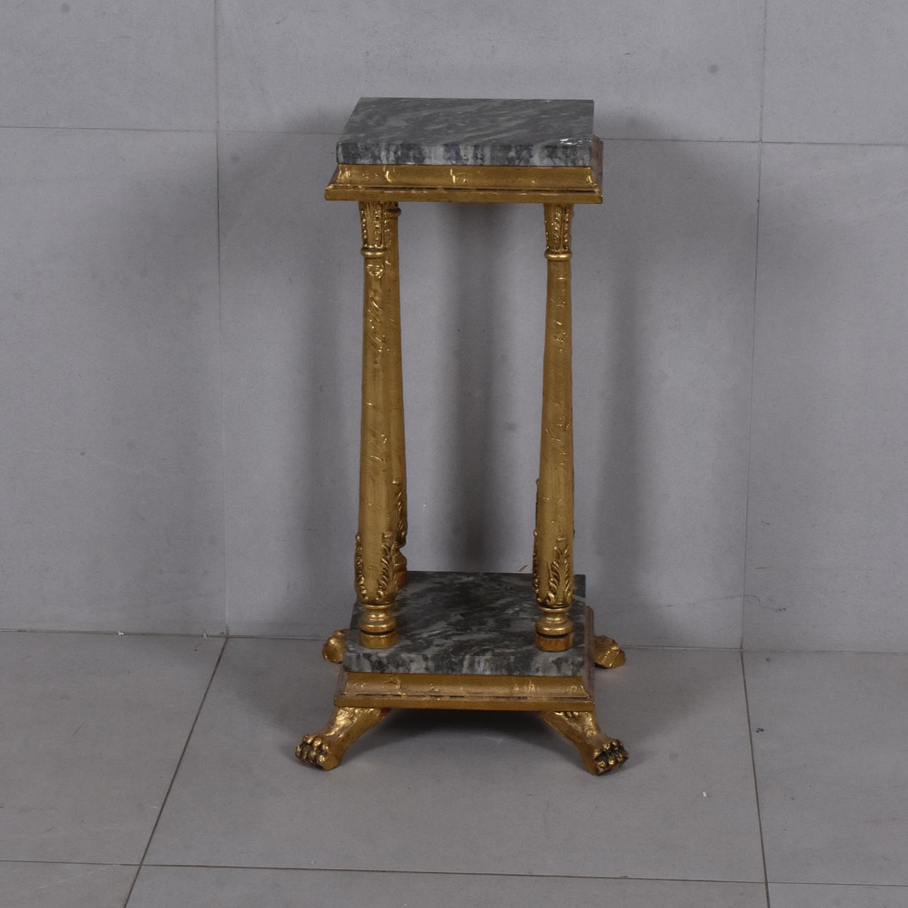 PEDESTAL, gilded with marble panels.
