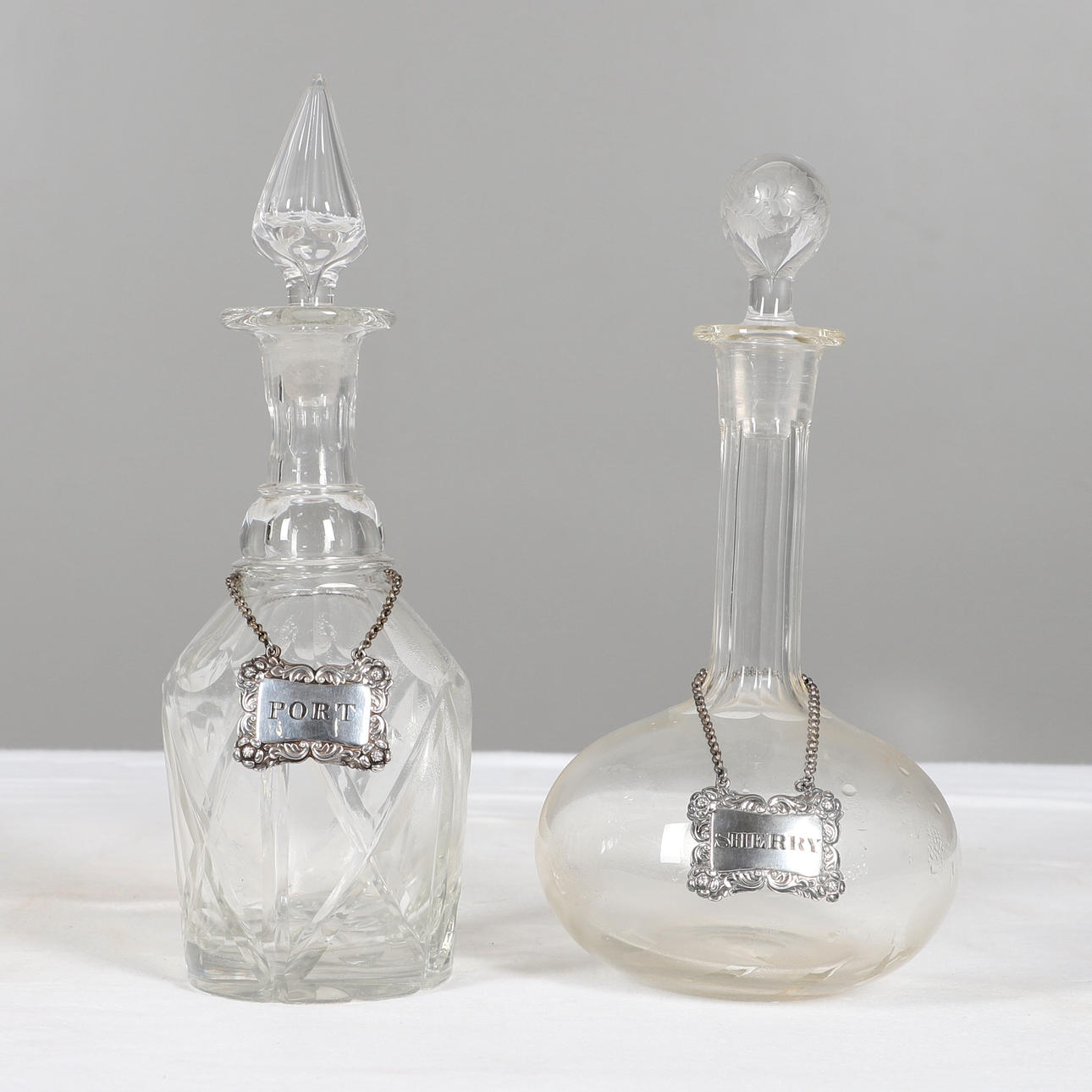 GLASS DECANTERS & SILVER SPIRIT LABELS.